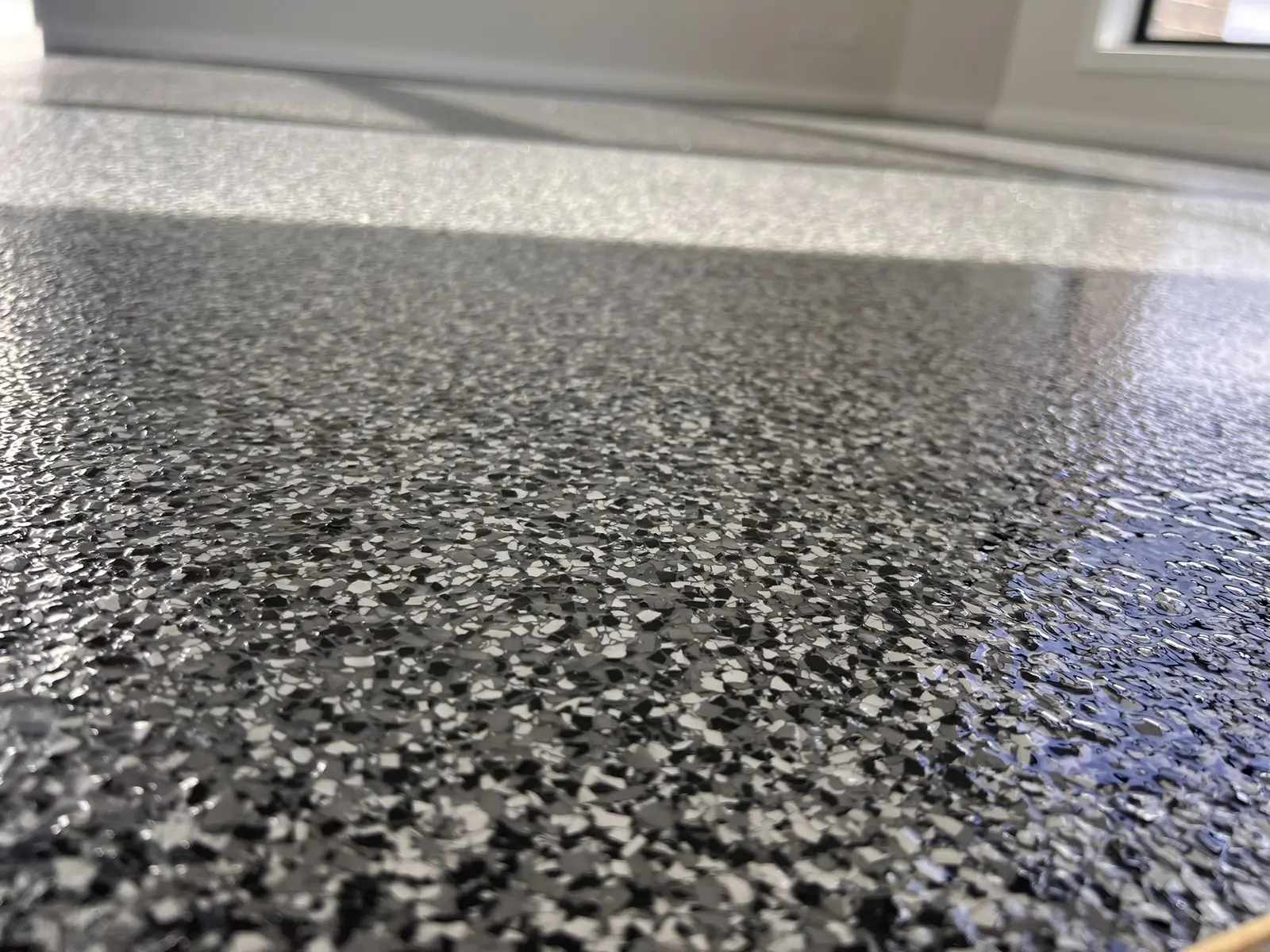 Black, white and grey decorative flake garage coating close-up