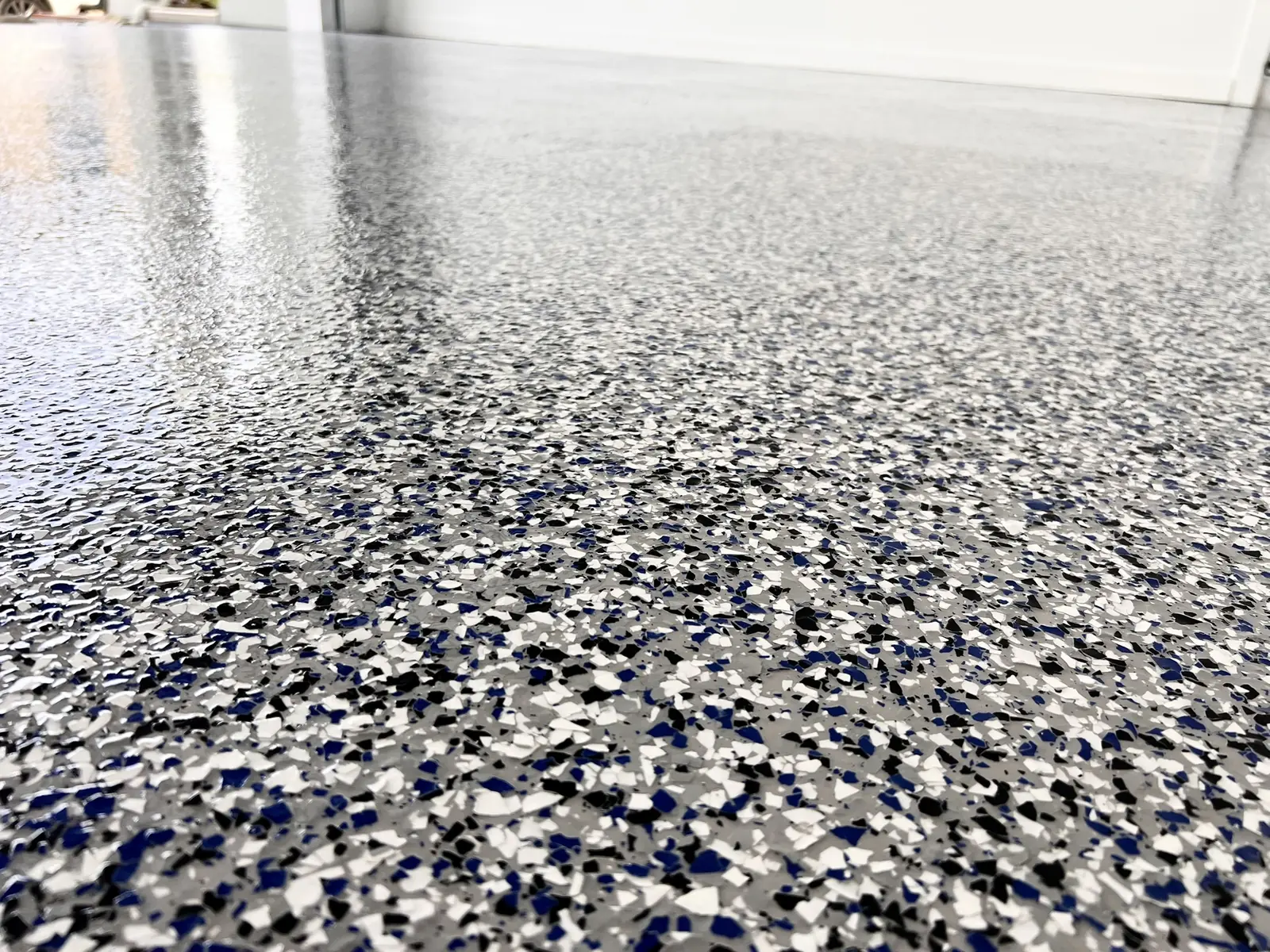 Blue, grey and white decorative flake garage floor close-up