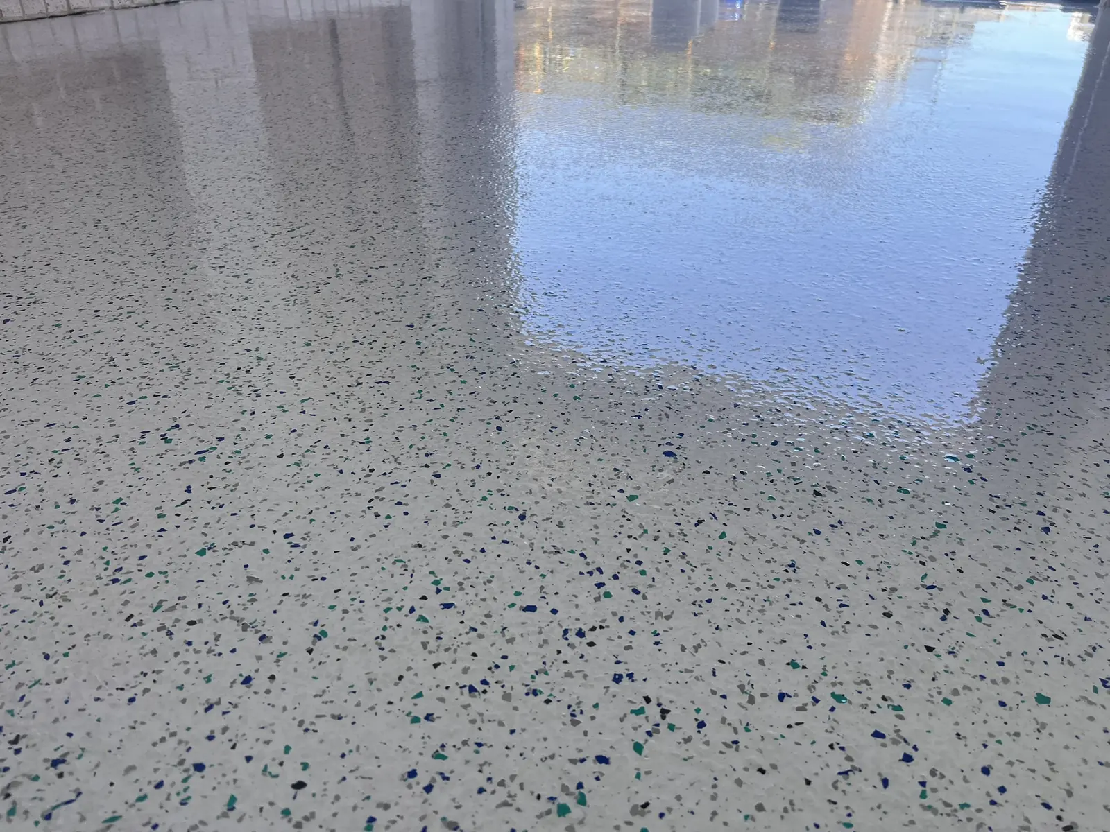 Wide view of a blue and teal decorative flake garage floor
