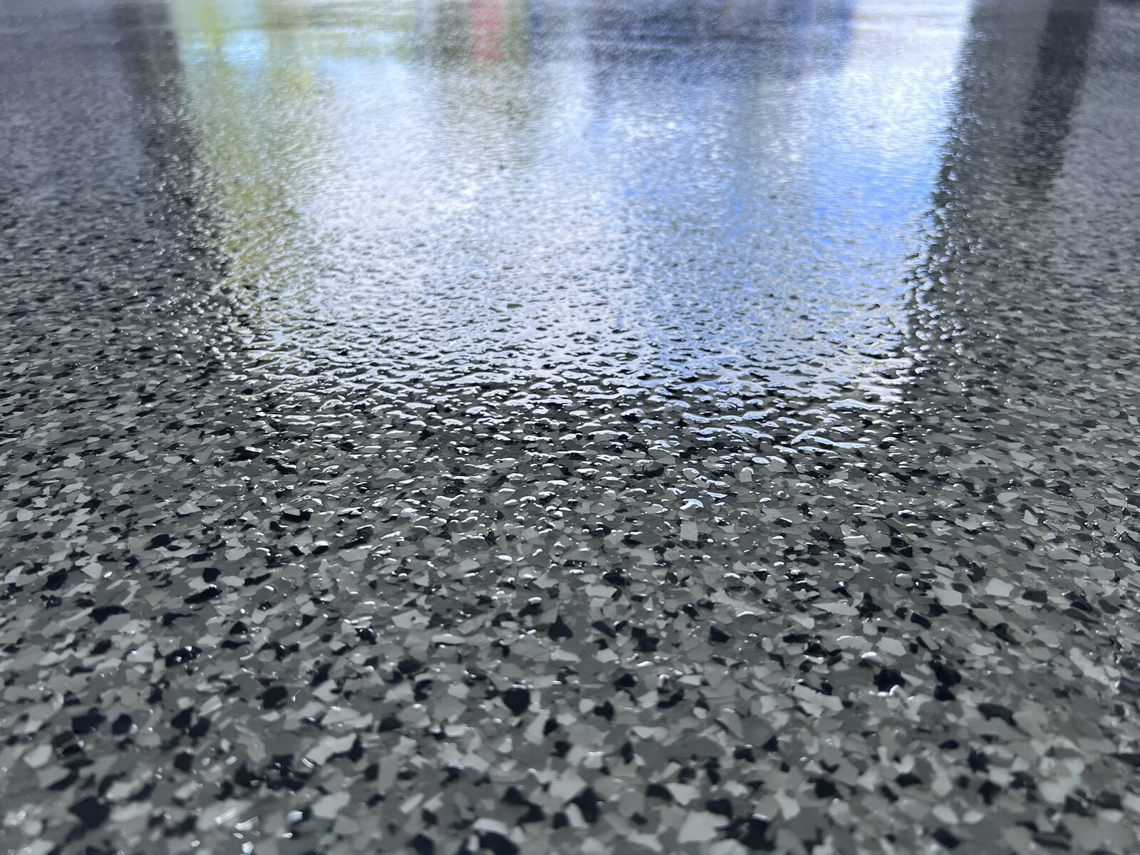 Grey and black decorative flake garage floor close-up