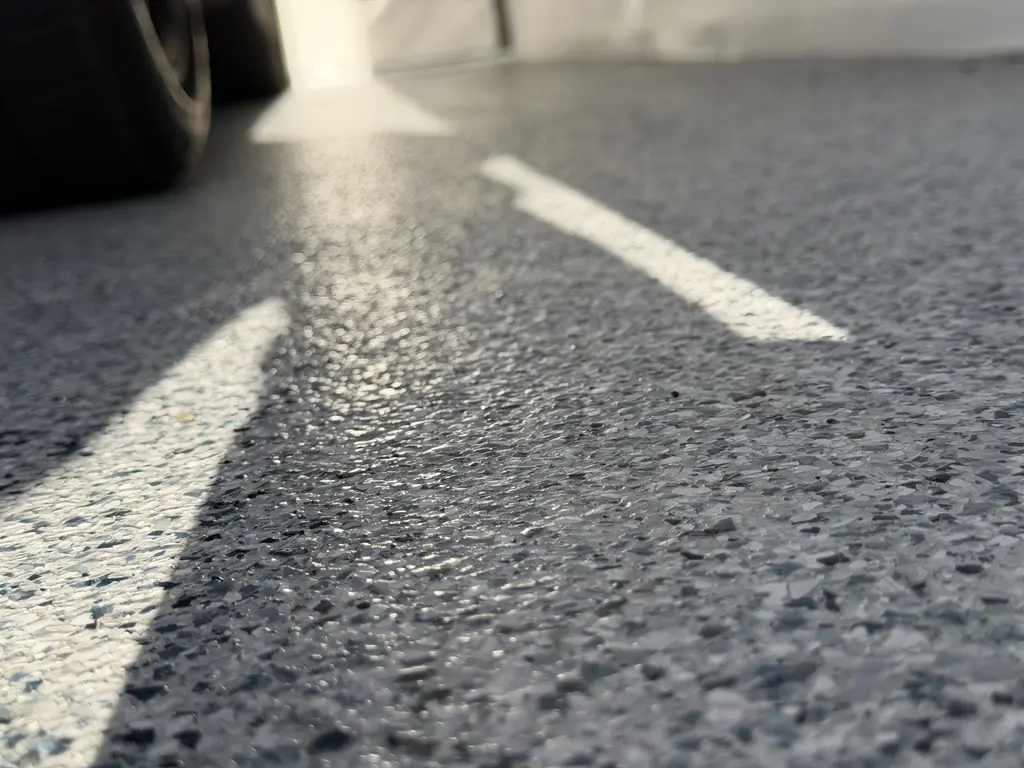Grey decorative flake garage floor highlighted by natural light