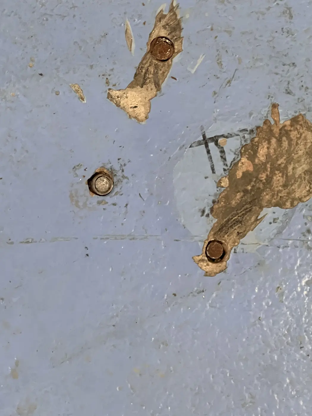 Damaged coating around floor penetrations before surface repair