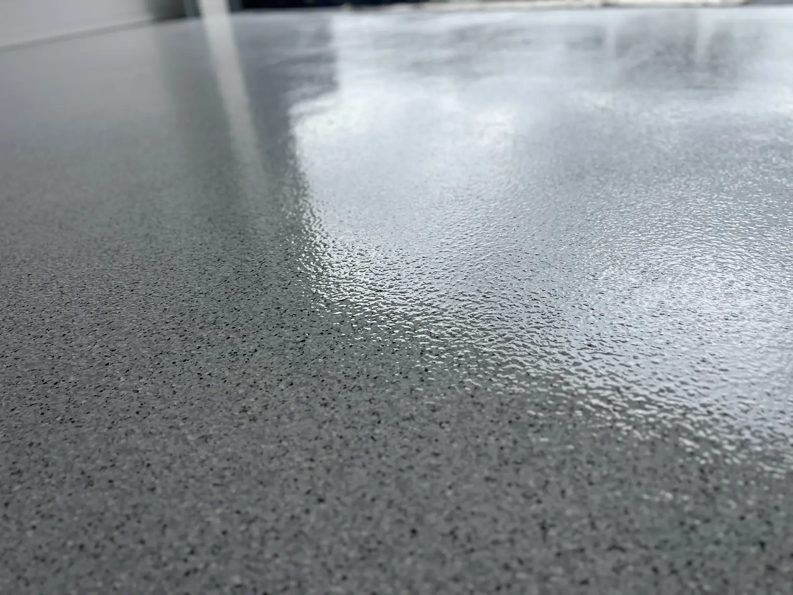 Plain grey protective coating across a residential garage floor