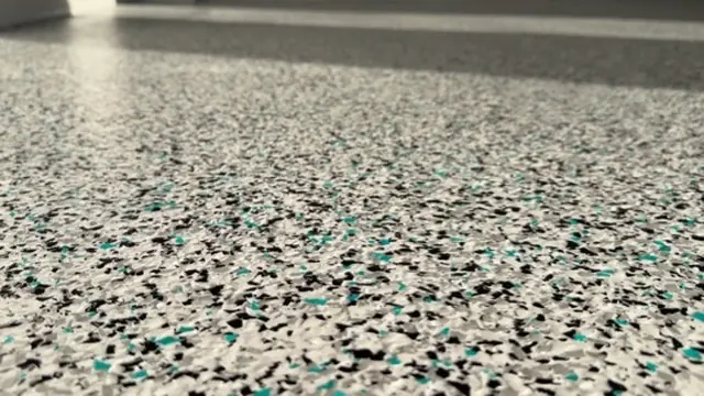 Teal, black and grey decorative flake garage floor detail
